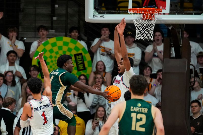 Jan 27, 2024; Laramie, Wyoming, USA; Colorado State Rams forward Isaiah Stevens (4) looks to pass around Wyoming Cowboys forward Caden Powell (44) during overtime at Arena-Auditorium. Mandatory Credit: Troy Babbitt-USA TODAY Sports