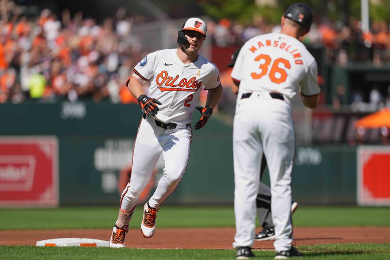 Sep 2, 2024; Baltimore, Maryland, USA; Baltimore Orioles shortstop Gunnar Henderson (2) is greeted by coach Tony Mansolino (36) following his first inning solo home run against the Chicago White Sox at Oriole Park at Camden Yards. Mandatory Credit: Mitch Stringer-USA TODAY Sports