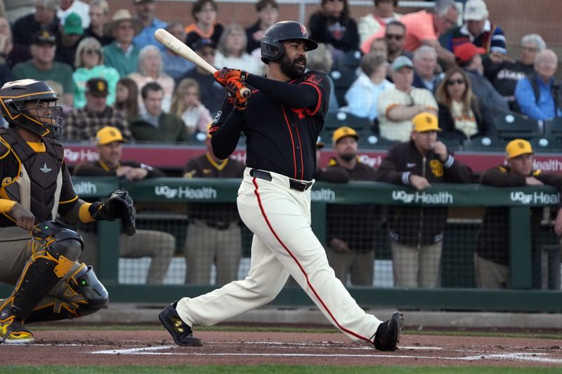 Mar 18, 2025; Scottsdale, Arizona, USA; San Francisco Giants first base LaMonte Wade Jr. (31) hits a single against the San Diego Padres in the first inning at Scottsdale Stadium. Mandatory Credit: Rick Scuteri-Imagn Images
