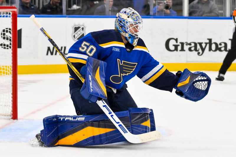 Nov 21, 2024; St. Louis, Missouri, USA;  St. Louis Blues goaltender Jordan Binnington (50) defends the net against the San Jose Sharks during the third period at Enterprise Center. Mandatory Credit: Jeff Curry-Imagn Images