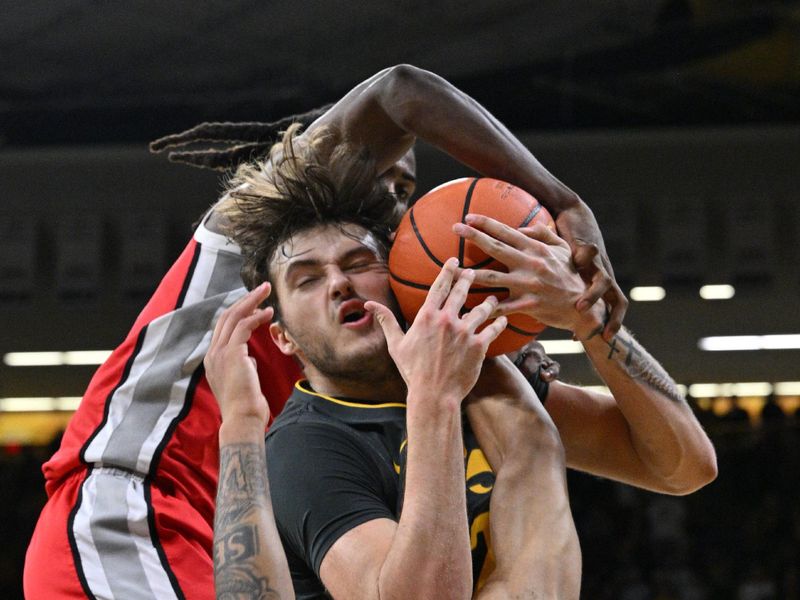 Feb 2, 2024; Iowa City, Iowa, USA; Iowa Hawkeyes forward Owen Freeman (32) and Ohio State Buckeyes center Felix Okpara (rear) and guard Roddy Gayle Jr. (1) battle for a rebound during the second half at Carver-Hawkeye Arena. Mandatory Credit: Jeffrey Becker-USA TODAY Sports