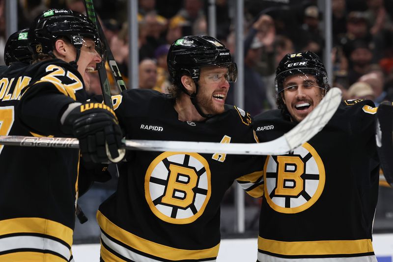 Oct 28, 2025; Boston, Massachusetts, USA; Boston Bruins right wing David Pastrnak (88) (center) celebrates his goal with defenseman Hampus Lindholm (27) and center Marat Khusnutdinov (92) during the second period against the New York Islanders at TD Garden. Mandatory Credit: Winslow Townson-Imagn Images