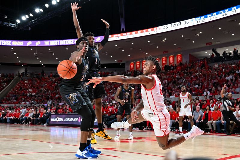 Feb 19, 2023; Houston, Texas, USA; Houston Cougars guard Marcus Sasser (0) passes the ball around Memphis Tigers forward Malcolm Dandridge (23) during the second half at Fertitta Center. Mandatory Credit: Maria Lysaker-USA TODAY Sports