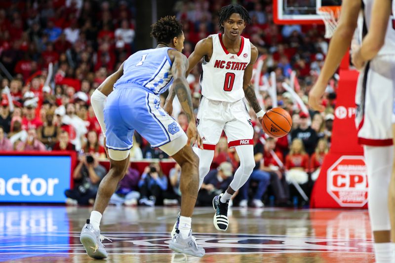 Feb 19, 2023; Raleigh, North Carolina, USA; North Carolina State Wolfpack guard Terquavion Smith (0) dribbles against North Carolina Tar Heels forward Leaky Black (1) during the first half of the game at PNC Arena. Mandatory Credit: Jaylynn Nash-USA TODAY Sports