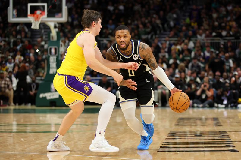 MILWAUKEE, WISCONSIN - MARCH 26: Damian Lillard #0 of the Milwaukee Bucks is defended by Austin Reaves #15 of the Los Angeles Lakers during the first half of a game at Fiserv Forum on March 26, 2024 in Milwaukee, Wisconsin. NOTE TO USER: User expressly acknowledges and agrees that, by downloading and or using this photograph, User is consenting to the terms and conditions of the Getty Images License Agreement. (Photo by Stacy Revere/Getty Images)