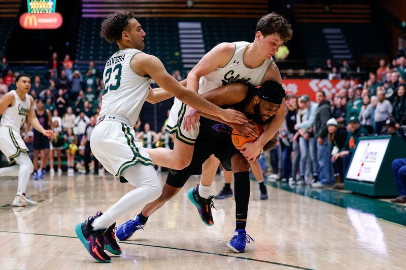 Feb 15, 2023; Fort Collins, Colorado, USA; Boise State Broncos forward Naje Smith (23) controls the ball as he is fouled by Colorado State Rams forward Patrick Cartier (12) as guard Isaiah Rivera (23) defends in the second half at Moby Arena. Mandatory Credit: Isaiah J. Downing-USA TODAY Sports