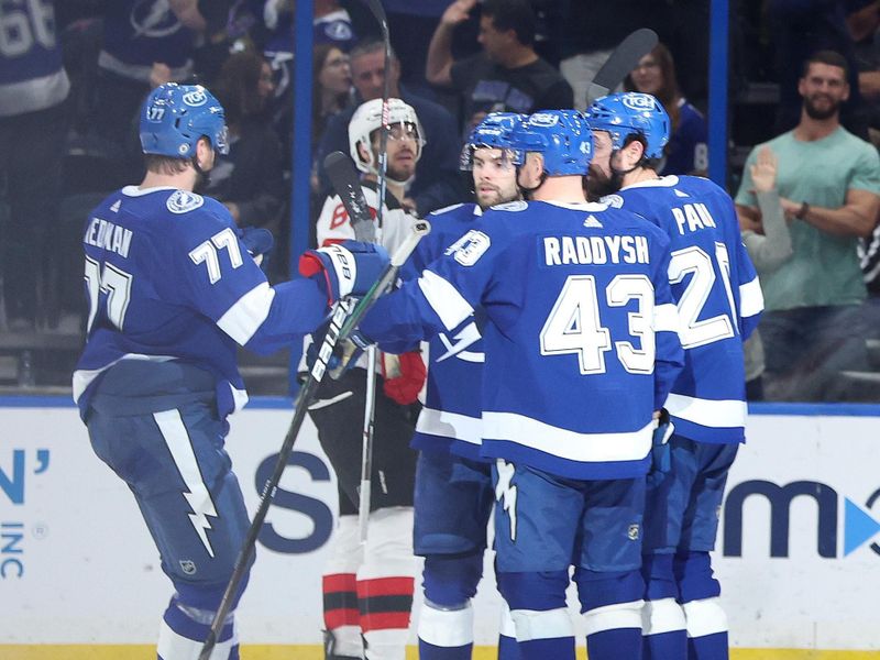 Jan 27, 2024; Tampa, Florida, USA; Tampa Bay Lightning left wing Nicholas Paul (20) is congratulated after he scored a goal against the New Jersey Devils during the second period at Amalie Arena. Mandatory Credit: Kim Klement Neitzel-USA TODAY Sports