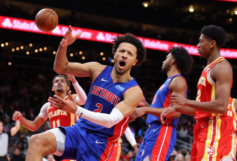 ATLANTA, GEORGIA - DECEMBER 18:  Cade Cunningham #2 of the Detroit Pistons reacts as he draws a foul after dunking against Trae Young #11 of the Atlanta Hawks during the fourth quarter at State Farm Arena on December 18, 2023 in Atlanta, Georgia.  NOTE TO USER: User expressly acknowledges and agrees that, by downloading and/or using this photograph, user is consenting to the terms and conditions of the Getty Images License Agreement.  (Photo by Kevin C. Cox/Getty Images)