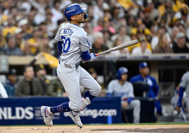 Oct 9, 2024; San Diego, California, USA; Los Angeles Dodgers shortstop Mookie Betts (50) hits a home run in the first inning against the San Diego Padres during game four of the NLDS for the 2024 MLB Playoffs at Petco Park.  Mandatory Credit: Denis Poroy-Imagn Images