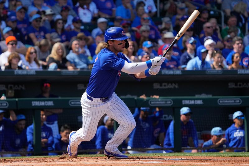 Mar 14, 2024; Mesa, Arizona, USA; Chicago Cubs second baseman Nico Hoerner (2) hits a single against the Oakland Athletics in the first inning at Sloan Park. Mandatory Credit: Rick Scuteri-USA TODAY Sports