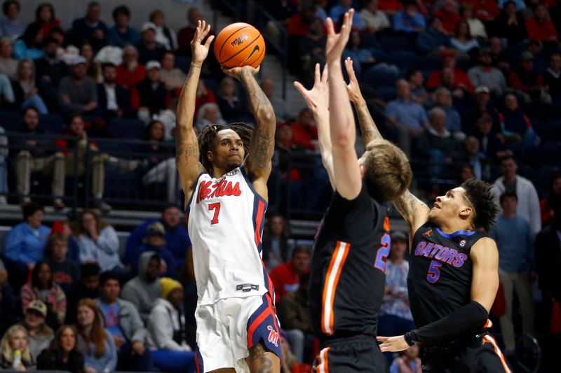 Jan 10, 2024; Oxford, Mississippi, USA; Mississippi Rebels guard Allen Flanigan (7) shoots over Florida Gators forward/center Alex Condon (21) and guard Will Richard (5) during the second half at The Sandy and John Black Pavilion at Ole Miss. Mandatory Credit: Petre Thomas-USA TODAY Sports