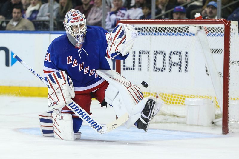 Jan 8, 2024; New York, New York, USA;  New York Rangers goaltender Igor Shesterkin (31) makes a save on a shot on goal attempt in the second period against the Vancouver Canucks at Madison Square Garden. Mandatory Credit: Wendell Cruz-USA TODAY Sports