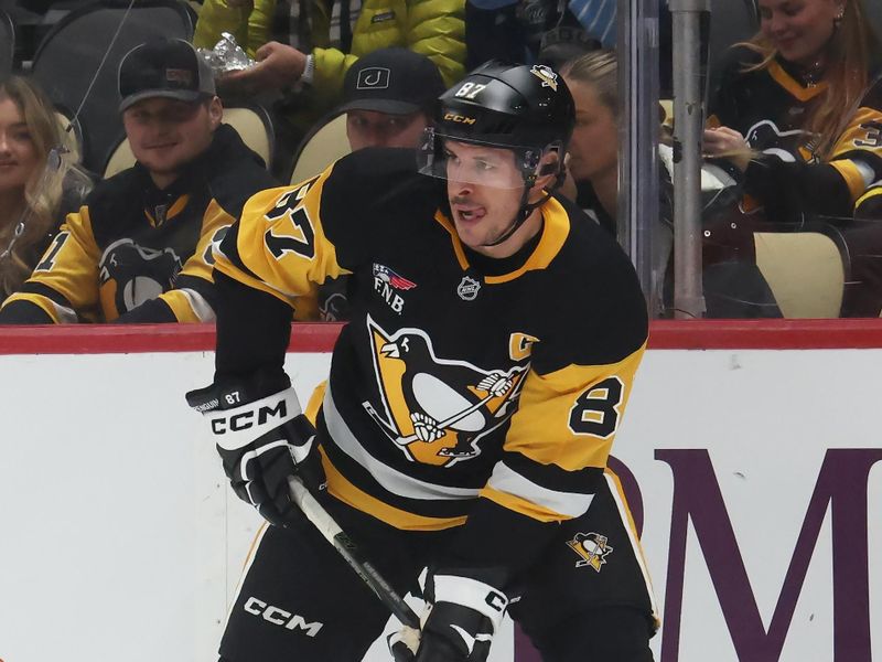 Dec 9, 2025; Pittsburgh, Pennsylvania, USA;  Pittsburgh Penguins center Sidney Crosby (87) handles the puck against the Anaheim Ducks during the first period at PPG Paints Arena. Mandatory Credit: Charles LeClaire-Imagn Images