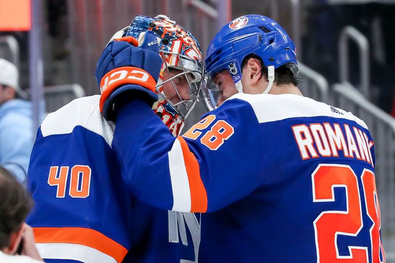 Apr 6, 2024; Elmont, New York, USA; New York Islanders goaltender Semyon Varlamov (40) celebrates with defenseman Alexander Romanov (28) after the game against the Nashville Predators at UBS Arena. Mandatory Credit: Tom Horak-USA TODAY Sports