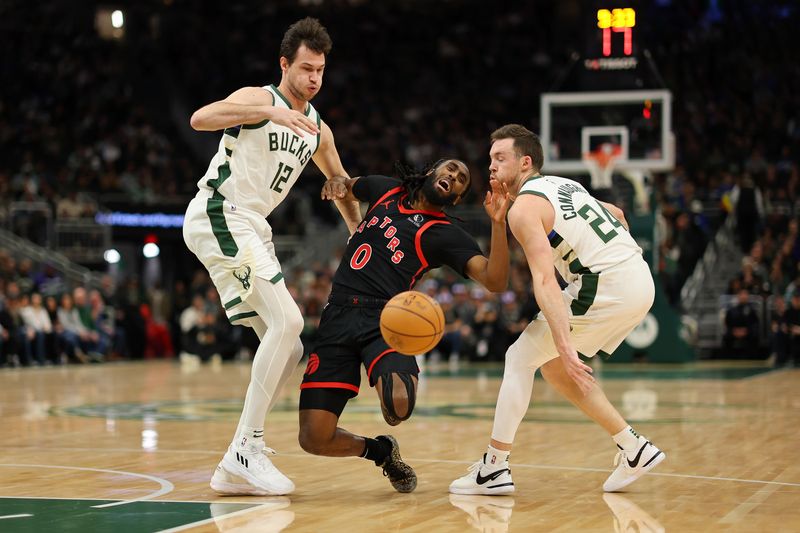 MILWAUKEE, WISCONSIN - APRIL 05: Javon Freeman-Liberty #0 of the Toronto Raptors is fouled by Pat Connaughton #24 of the Milwaukee Bucks during the first half of a game at Fiserv Forum on April 05, 2024 in Milwaukee, Wisconsin. NOTE TO USER: User expressly acknowledges and agrees that, by downloading and or using this photograph, User is consenting to the terms and conditions of the Getty Images License Agreement. (Photo by Stacy Revere/Getty Images)