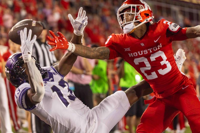 Sep 16, 2023; Houston, Texas, USA; TCU Horned Frogs wide receiver Jaylon Robinson (13) drops a pass against Houston Cougars defensive back Isaiah Hamilton (23) in the second half at TDECU Stadium. Mandatory Credit: Thomas Shea-USA TODAY Sports