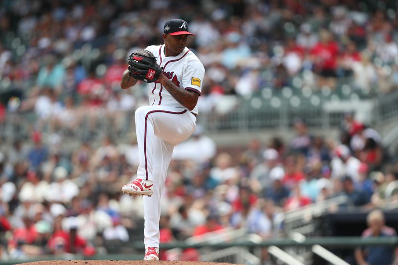 Jun 29, 2025; Cumberland, Georgia, Atlanta Braves relief pitcher Raisel Iglesias (26) pitches during a game against the Philadelphia Phillies during the ninth inning at Truist Park. Mandatory Credit: Mady Mertens-Imagn Images