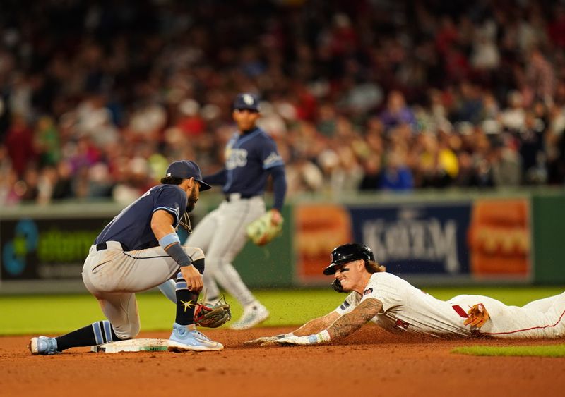 May 13, 2024; Boston, Massachusetts, USA; Boston Red Sox center fielder Jarren Duran (16) out stealing second base by Tampa Bay Rays shortstop Jose Caballero (7) in the fifth inning at Fenway Park. Mandatory Credit: David Butler II-USA TODAY Sports