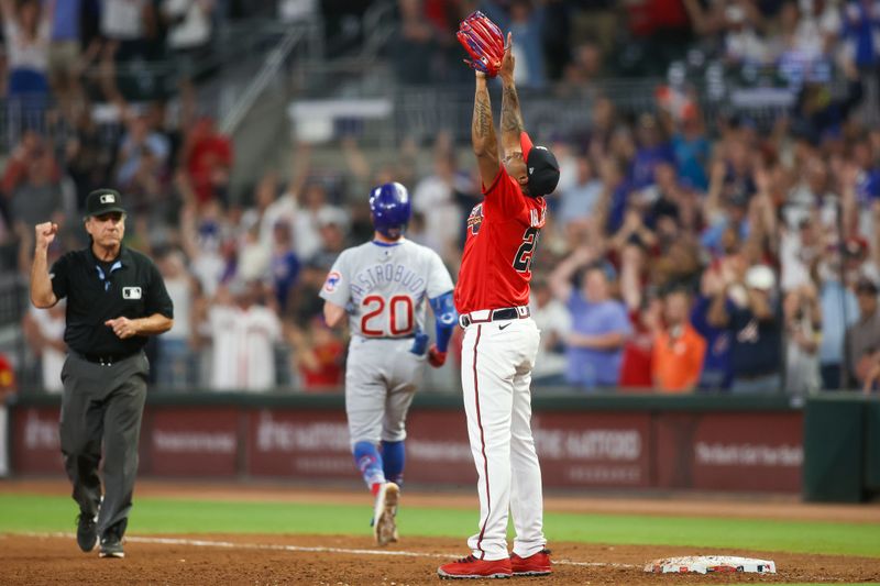 Sep 28, 2023; Atlanta, Georgia, USA; Atlanta Braves relief pitcher Raisel Iglesias (26) celebrates after a victory against the Chicago Cubs at Truist Park. Mandatory Credit: Brett Davis-USA TODAY Sports
