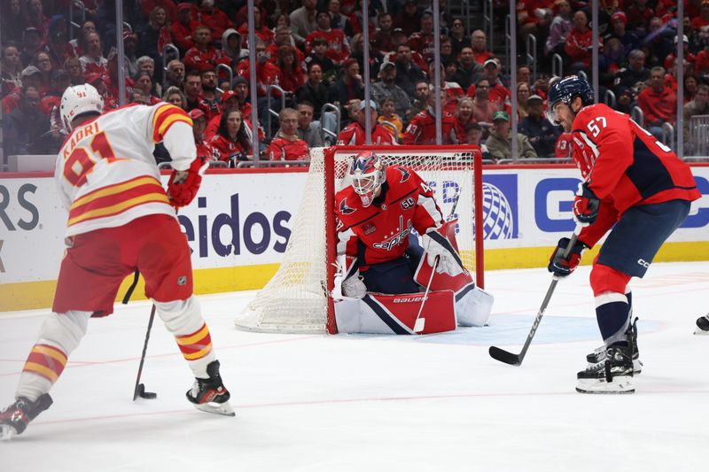 Feb 25, 2025; Washington, District of Columbia, USA; Calgary Flames center Nazem Kadri (91) prepares to shoot the puck on .Washington Capitals goaltender Logan Thompson (48) as Capitals defenseman Trevor van Riemsdyk (57) defends in the second period at Capital One Arena. Mandatory Credit: Geoff Burke-Imagn Images