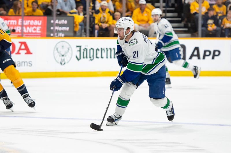 Apr 28, 2024; Nashville, Tennessee, USA; Vancouver Canucks left wing Nils Hoglander (21) skates against the Nashville Predators during the third period in game four of the first round of the 2024 Stanley Cup Playoffs at Bridgestone Arena. Mandatory Credit: Steve Roberts-USA TODAY Sports
