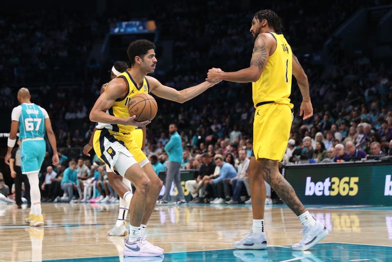 CHARLOTTE, NC - NOVEMBER 8: Obi Toppin #1 helps teammate Ben Sheppard #26 of the Indiana Pacers on off the floor during the game against the Charlotte HornetsNovember 8, 2024 at Spectrum Center in Charlotte, North Carolina. NOTE TO USER: User expressly acknowledges and agrees that, by downloading and or using this photograph, User is consenting to the terms and conditions of the Getty Images License Agreement. Mandatory Copyright Notice: Copyright 2024 NBAE (Photo by Brock Williams-Smith/NBAE via Getty Images)