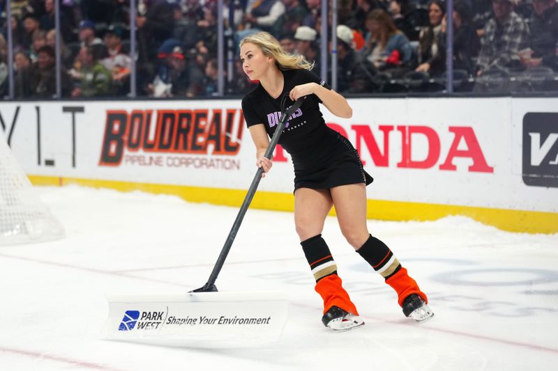 Nov 20, 2025; Anaheim, California, USA; An Anaheim Ducks power player ice crew member clears the ice in the first period at Honda Center. Mandatory Credit: Kirby Lee-Imagn Images