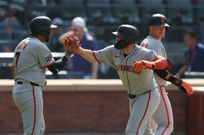 Aug 3, 2025; New York City, New York, USA; San Francisco Giants third baseman Casey Schmitt (10) celebrates with first baseman Dominic Smith (7) after hitting a three run home run during the ninth inning against the New York Mets at Citi Field. Mandatory Credit: Vincent Carchietta-Imagn Images