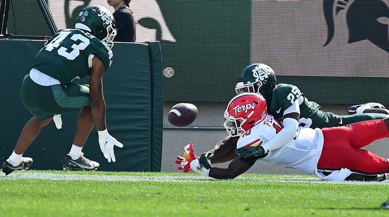 Sep 23, 2023; East Lansing, Michigan, USA;  Michigan State Spartans defensive back Chance Rucker (25) breaks up a pass to Maryland Terrapins wide receiver Tai Felton (10) in the first quarter as defensive back Malik Spencer (43) assists at Spartan Stadium. Mandatory Credit: Dale Young-USA TODAY Sports