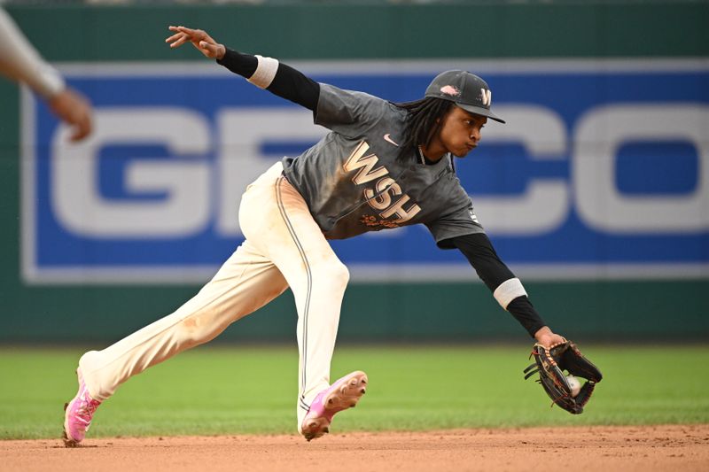 Aug 31, 2024; Washington, District of Columbia, USA; Washington Nationals shortstop CJ Abrams (5) fields a ground ball against the Chicago Cubs during the eighth inning at Nationals Park. Mandatory Credit: Rafael Suanes-USA TODAY Sports