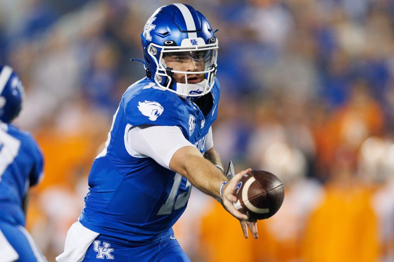 Oct 28, 2023; Lexington, Kentucky, USA; Kentucky Wildcats quarterback Devin Leary (13) hands the ball off during the first quarter against the Tennessee Volunteers at Kroger Field. Mandatory Credit: Jordan Prather-USA TODAY Sports