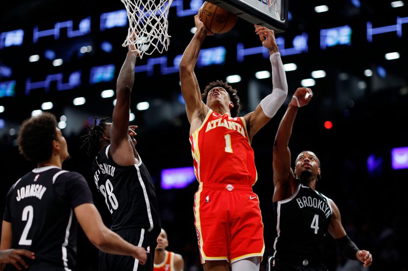 NEW YORK, NEW YORK - MARCH 02: Jalen Johnson #1 of the Atlanta Hawks goes to the basket as Dennis Smith Jr. #4 and Dorian Finney-Smith #28 of the Brooklyn Nets defend during the second half at Barclays Center on March 02, 2024 in the Brooklyn borough of New York City. The Nets won 114-102. NOTE TO USER: User expressly acknowledges and agrees that, by downloading and or using this photograph, User is consenting to the terms and conditions of the Getty Images License Agreement. (Photo by Sarah Stier/Getty Images)