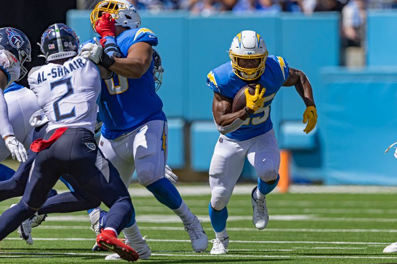 Los Angeles Chargers running back Joshua Kelley (25) runs for yardage during their NFL football game against the Tennessee Titans Sunday, Sept. 17, 2023, in Nashville, Tenn. (AP Photo/Wade Payne)