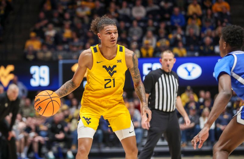 Feb 3, 2024; Morgantown, West Virginia, USA; West Virginia Mountaineers guard RaeQuan Battle (21) dribbles the ball during the second half against the Brigham Young Cougars at WVU Coliseum. Mandatory Credit: Ben Queen-USA TODAY Sports