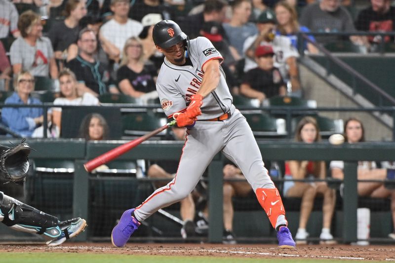 Jun 30, 2025; Phoenix, Arizona, USA;  San Francisco Giants shortstop Willy Adames (2) singles in the seventh inning against the Arizona Diamondbacks at Chase Field. Mandatory Credit: Matt Kartozian-Imagn Images