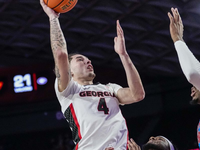 Feb 7, 2023; Athens, Georgia, USA; Georgia Bulldogs guard Jusaun Holt (4) shoots over top of Mississippi Rebels guard Amaree Abram (1) during the second half at Stegeman Coliseum. Mandatory Credit: Dale Zanine-USA TODAY Sports