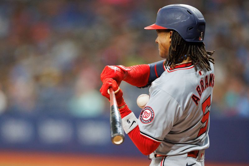 Jun 28, 2024; St. Petersburg, Florida, USA;  Washington Nationals shortstop CJ Abrams (5) is hit by a pitch against the Tampa Bay Rays in the seventh inning at Tropicana Field. Mandatory Credit: Nathan Ray Seebeck-USA TODAY Sports