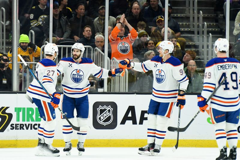 Jan 7, 2025; Boston, Massachusetts, USA; Edmonton Oilers center Adam Henrique (19) is congratulated by defenseman Brett Kulak (27) and right wing Corey Perry (90) after scoring a goal during the first period against the Boston Bruins at TD Garden. Mandatory Credit: Bob DeChiara-Imagn Images