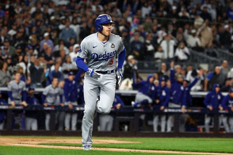 Oct 29, 2024; Bronx, New York, USA; Los Angeles Dodgers first baseman Freddie Freeman (5) reacts after hitting a two run home run against the New York Yankees in the first inning during game four of the 2024 MLB World Series at Yankee Stadium. Mandatory Credit: Vincent Carchietta-Imagn Images