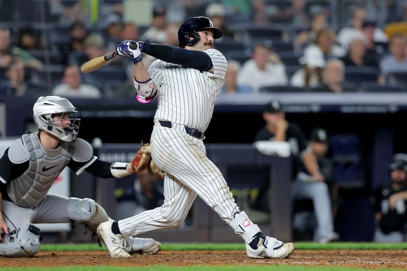 Sep 25, 2025; Bronx, New York, USA; New York Yankees catcher Austin Wells (28) follows through on an RBI double against the Chicago White Sox during the seventh inning at Yankee Stadium. Mandatory Credit: Brad Penner-Imagn Images