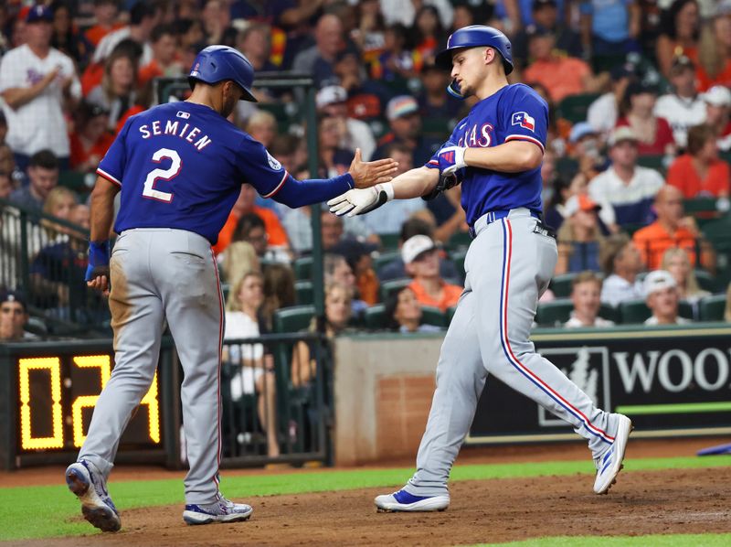 Jul 12, 2024; Houston, Texas, USA; Texas Rangers second baseman Marcus Semien (2) celebrates shortstop Corey Seager (5) two run home run against the Houston Astros  in the sixth inning at Minute Maid Park. Mandatory Credit: Thomas Shea-USA TODAY Sports