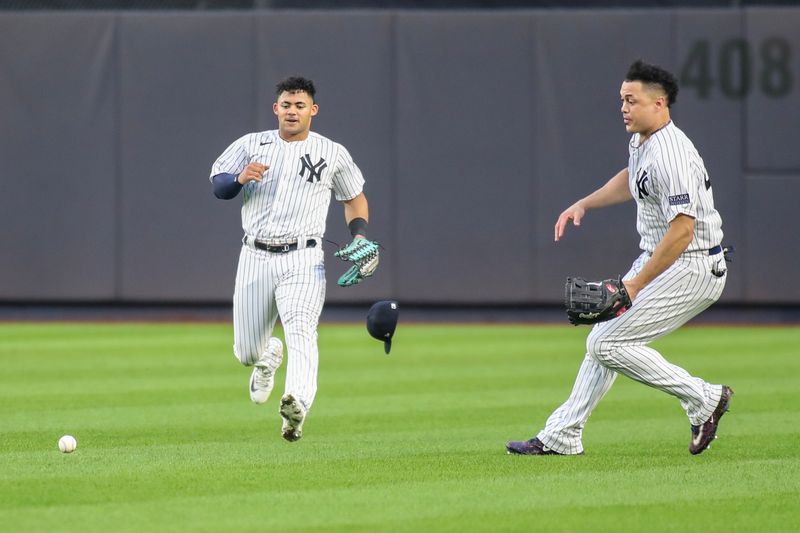 Sep 9, 2023; Bronx, New York, USA; The ball drops in front of New York Yankees center fielder Jasson Dominguez (89) and right fielder Giancarlo Stanton (27) allowing a run to score in the eighth inning against the Milwaukee Brewers at Yankee Stadium. Mandatory Credit: Wendell Cruz-USA TODAY Sports