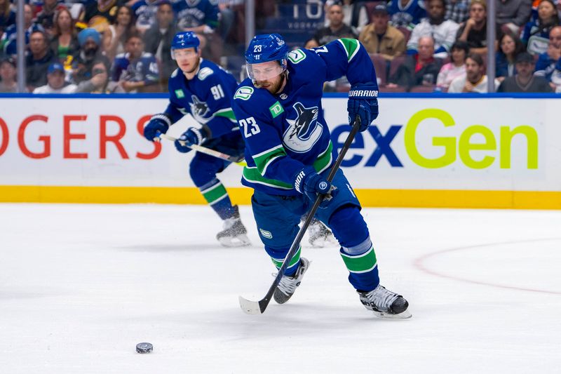 May 20, 2024; Vancouver, British Columbia, CAN; Vancouver Canucks forward Elias Lindholm (23) handles the puck against the Edmonton Oilers during the first period in game seven of the second round of the 2024 Stanley Cup Playoffs at Rogers Arena. Mandatory Credit: Bob Frid-USA TODAY Sports