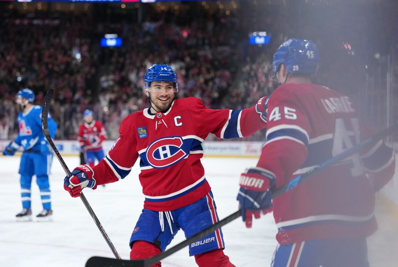 Jan 29, 2026; Montreal, Quebec, CAN; Montreal Canadiens defenseman Alexandre Carrier (45) celebrates with teammate forward Nick Suzuki (14) after scoring a goal against the Colorado Avalanche during the third period at the Bell Centre. Mandatory Credit: Eric Bolte-Imagn Images