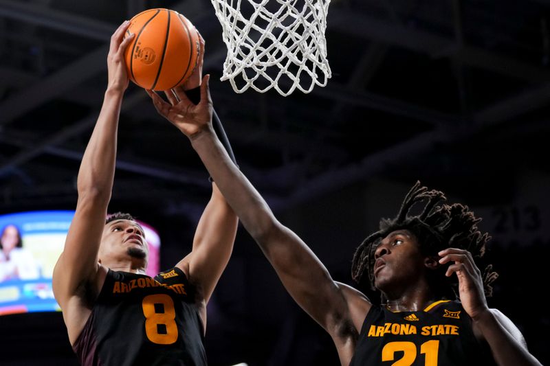 Jan 18, 2025; Cincinnati, Ohio, USA;  Arizona State Sun Devils forward Basheer Jihad (8) rebounds the ball alongside forward Jayden Quaintance (21) in the game against the Cincinnati Bearcats in the first half at Fifth Third Arena. Mandatory Credit: Aaron Doster-Imagn Images