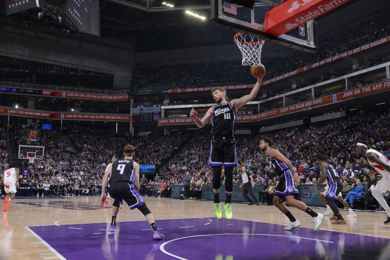 SACRAMENTO, CA - JANUARY 5: Domantas Sabonis #10 of the Sacramento Kings grabs the rebound during the game against the Toronto Raptors on January 5, 2024 at Golden 1 Center in Sacramento, California. NOTE TO USER: User expressly acknowledges and agrees that, by downloading and or using this Photograph, user is consenting to the terms and conditions of the Getty Images License Agreement. Mandatory Copyright Notice: Copyright 2024 NBAE (Photo by Rocky Widner/NBAE via Getty Images)