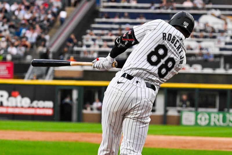 Jun 7, 2024; Chicago, Illinois, USA;  Chicago White Sox outfielder Luis Robert Jr. (88) hits a home run against the Boston Red Sox during the first inning at Guaranteed Rate Field. Mandatory Credit: Matt Marton-USA TODAY Sports