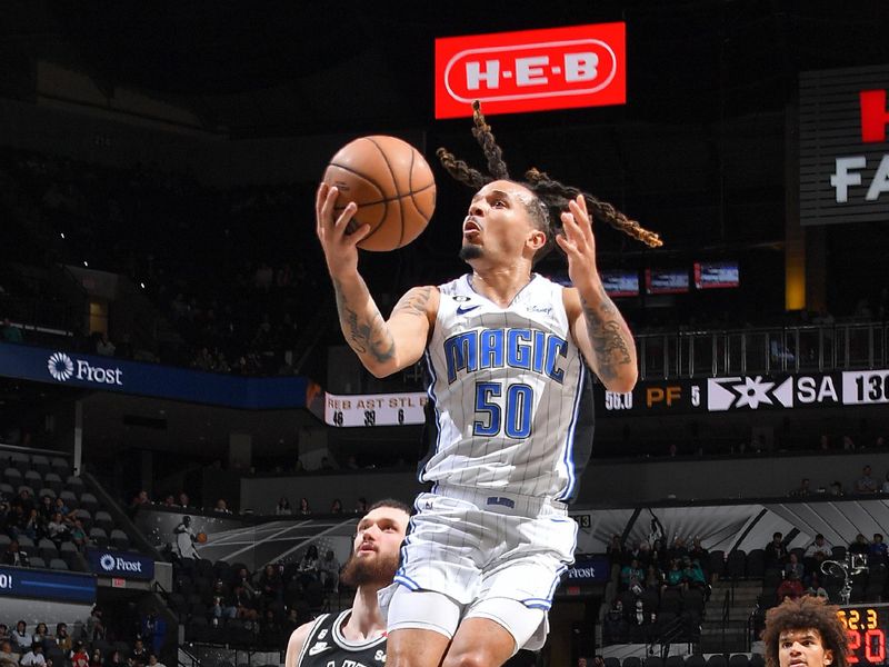 SAN ANTONIO, TX - MARCH 14: Cole Anthony #50 of the Orlando Magic drives to the basket during the game against the San Antonio Spurs on March 14, 2023 at the AT&T Center in San Antonio, Texas. NOTE TO USER: User expressly acknowledges and agrees that, by downloading and or using this photograph, user is consenting to the terms and conditions of the Getty Images License Agreement. Mandatory Copyright Notice: Copyright 2023 NBAE (Photos by Michael Gonzales/NBAE via Getty Images)