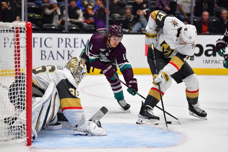 Dec 27, 2023; Anaheim, California, USA; Anaheim Ducks center Trevor Zegras (11) moves in for the puck against Vegas Golden Knights defenseman Ben Hutton (17) and goaltender Logan Thompson (36) during the first period at Honda Center. Mandatory Credit: Gary A. Vasquez-USA TODAY Sports