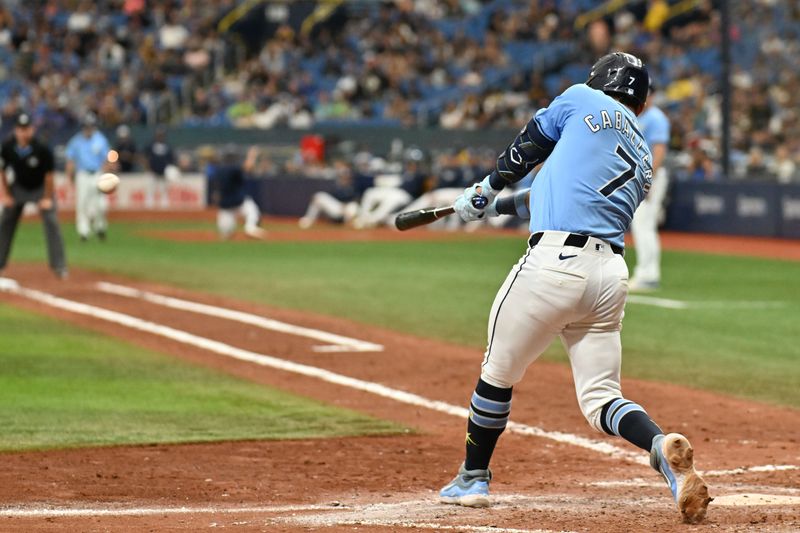 Sep 22, 2024; St. Petersburg, Florida, USA; Tampa Bay Rays second baseman Jose Caballero (7) hits a single in the seventh inning against the Toronto Blue Jays at Tropicana Field. Mandatory Credit: Jonathan Dyer-Imagn Images